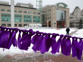 Thirteen thousand purple ribbons are hung around Ottawa City Hall Monday in honour of the National Day of Remembrance and Action on Violence Against Women. The ribbons represent every household waiting on subsidized housing as that is one of the main obstacles for women escaping domestic violence.