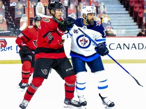 Ottawa Senators defenceman Jacob Bernard-Docker (48) checks Winnipeg Jets left wing Mathieu Perreault (85) during second period NHL action at the Canadian Tire Centre, April 14, 2021.