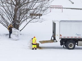 City of Ottawa crews removed sign posts and placed bales of hay and foam to act as barriers to other obstacles at the Mooney's Bay Park hill where an 11-year-old girl died in a sledding accident Dec. 27.