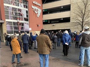 People line up outside the uOttawa Athletic Centre waiting to get a booster shot.