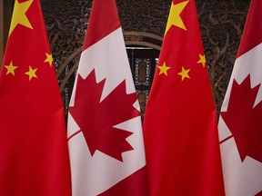 (FILES) In this file photo taken on December 5, 2017 shows Canadian and Chinese flags taken prior to a meeting with Canada's Prime Minister Justin Trudeau and China's President Xi Jinping at the Diaoyutai State Guesthouse in Beijing.