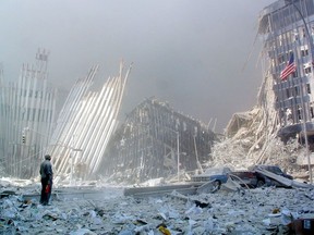 A man stands in the rubble of the twin towers of the World Trade Center in lower Manhattan on Sept. 11, 2001. Canada's anti-terrorism legislation was introduced after these attacks.