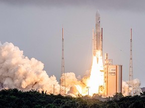 TOPSHOT - Arianespace's Ariane 5 rocket with NASAs James Webb Space Telescope onboard lifts up from the launchpad, at the Europes Spaceport, the Guiana Space Center in Kourou, French Guiana, on December 25, 2021.