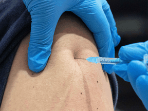 A different man gets a COVID vaccine shot in his real arm. The man in Italy had a sophisticated fake arm made of silicon.