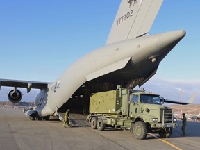 Canadian Forces equipment for Reverse Osmosis Water Purification is unloaded from a military transport aircraft, which was requested after officials in the northern territory said lab results confirmed that fuel had entered its water supply in Iqaluit, Nunavut, Oct. 23, 2021.