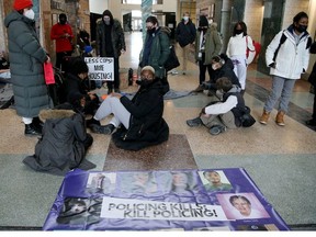 A group of about 20 people staged a sit-in at Ottawa City Hall Wednesday, principally protesting increasing the police budget.