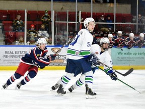The Cornwall Colts' Tristan Miron, left, and the Hawkesbury Hawks' Bradley Horner and William Gendron track the puck during a CCHL game on Dec. 12 in Cornwall. The Colts lost 3-2.