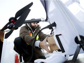 Safety pilot Abrahim Mardani demonstrates loading a package into a new delivery drone at the Edmonton International Airport, on Friday, Dec. 3, 2021. This is Canada's first drone delivery operation from within an airport.