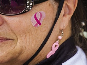 File: Breast cancer survivor Emily Little sports a pink ribbon on her face before competing in the Pink Ribbon Challenge during the final day of the 18th annual Edmonton Dragon Boat Festival at Louise McKinney Park in Edmonton, Alta., on Sunday, Aug. 17, 2014.