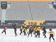 Hamilton Tiger-Cats teammates takes part in a practice at Tim Hortons Field during the CFL's Grey Cup week in Hamilton, Wednesday, December 8, 2021. The Hamilton Tiger-Cats will play the Winnipeg Blue Bombers in the 108th Grey Cup on Sunday.