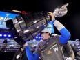 Winnipeg Blue Bombers quarterback Zach Collaros (8) hoists the trophy as he celebrates defeating the Hamilton Tiger-Cats in the 108th CFL Grey Cup in Hamilton, Ont., on Sunday, December 12, 2021.