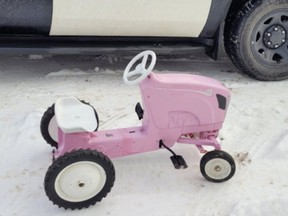 Members from Frontenac OPP helped make holiday dreams come true by bringing a pink tractor to a young boy who tried, unsuccessfully, to drive the family car to a store to buy a tractor for his sister.
