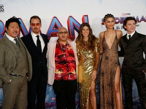 Cast members Benedict Wong, Benedict Cumberbatch, Jacob Batalon, Marisa Tomei, Zendaya and Tom Holland pose for a photograph as they attend the premiere for the film "Spider-Man: No Way Home" in Los Angeles, California, December 13, 2021.