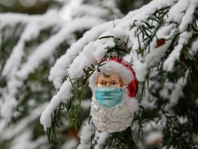 Files: A Christmas bauble shaped as Santa Claus wearing a protective mask is pictured amid the coronavirus disease (COVID-19) pandemic in Eichenau, Germany, November 26, 2021.