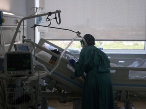 Files:Hospital staff member treats a patient suffering from the coronavirus disease (COVID-19) at a hospital in Spain
