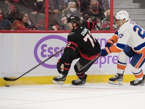 Senators defenceman Thomas Chabot (72) skates with the puck in front of New York Islanders left wing Anders Lee (27) in the first period at the Canadian Tire Centre.