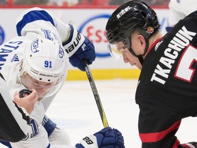 Senators captain Brady Tkachuk has his eyes on the puck as he faces off against the Lightning's Steven Stamkos in the second period of Saturday's game. Tkachuk also found time to produce his first NHL hat trick in Ottawa's 4-0 victory.