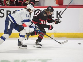 Tampa Bay Lightning left wing Pat Maroon (14) and Ottawa Senators right wing Tyler Ennis (63) chase the puck in the third period at the Canadian Tire Centre.