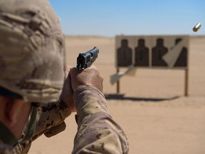 The Canadian military wants to replace its 1940s-era Browning handguns, shown in this 2015 photo being used by Canadian troops in the Middle East.