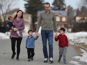 Dr. Winnie Siu with her husband Allan Reesor-McDowell and three kids Emerson (6), Owen (3) and Wesley (1) outside their Ottawa home. Winnie is a public-health doctor who chose to take parental leave in the midst of the COVID crisis.