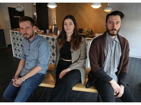 Eric Bimm, Sophie Bertrand and Alex Bimm pose for a photo at their new restaurant Le Poisson Bleu in Ottawa.