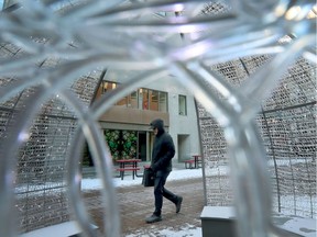 A man walks past some outdoor Christmas lights on Sparks Street in Ottawa.