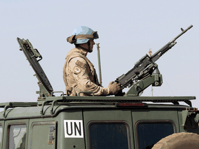 A Canadian Armed Forces soldier provides security as Prime Minister Justin Trudeau arrives to visit a United Nations mission in Gao, Mali, on Dec. 22, 2018.