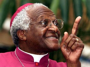 FILE PHOTO: Archbishop Desmond Tutu makes a point as he addresses a meeting March 16, 2001 to raise awareness for World Tuberculosis Day.