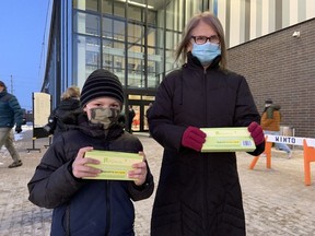 Lukas and Vilma Kaulins were among those who picked up their rapid test kits at the Minto Recreation Complex Friday morning.
