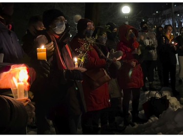 People held candles and roses at the annual memorial service in Minto Park to mark the National Day of Remembrance and Action on Violence Against Women on Monday, Dec. 6, 2021.