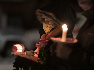 People held candles and roses at the annual memorial service in Minto Park to mark the National Day of Remembrance and Action on Violence Against Women on Monday, Dec. 6, 2021.