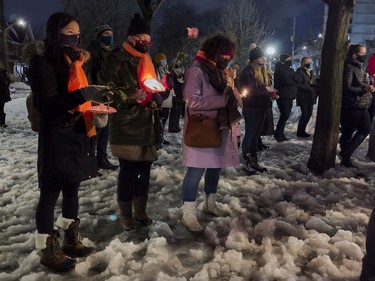 People held candles and roses at the annual memorial service in Minto Park to mark the National Day of Remembrance and Action on Violence Against Women on Monday, Dec. 6, 2021.