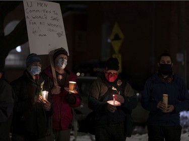 From left, Gilles Clouthier, Eric Girouard, Andrew Van Iterson and Philippe Clouthier hold candles at the annual memorial service in Minto Park to mark the National Day of Remembrance and Action on Violence Against Women.