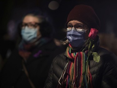 People held candles and roses at the annual memorial service in Minto Park to mark the National Day of Remembrance and Action on Violence Against Women on Monday, Dec. 6, 2021.