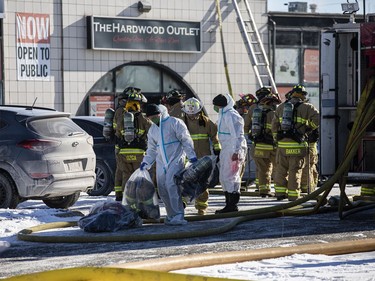 Firefighters and other first responders were on site of a three alarm fire on Colonnade Road South Saturday, January 8, 2022. Firefighters were leaving the scene with their gear in bags to be decontaminated back at the station.