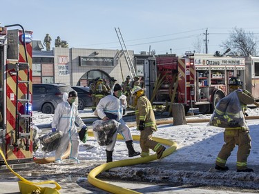 Firefighters and other first responders were on site of a three alarm fire on Colonnade Road South Saturday, January 8, 2022. Firefighters were leaving the scene with their gear in bags to be decontaminated back at the station.