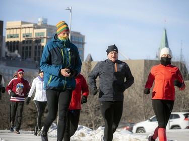 Lithuanian ambassador Darius Skusevicius, left, and Conservative Party of Canada Leader Erin O'Toole, middle, join the group leaving the starting area for Saturday's run near Ottawa City Hall.