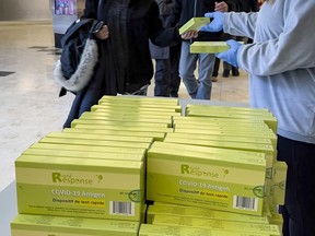 File: People pick up rapid antigen test kits at the Place d'Orléans Shopping Centre.