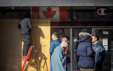 A store front was boarded up along Rideau Street Sunday.
