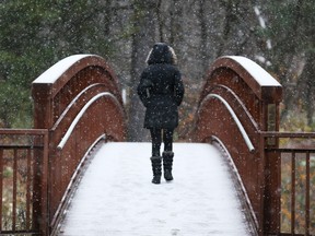 A walker crosses the bridge leading up to the Sugarbush trail in Gatineau Park in Old Chelsea.