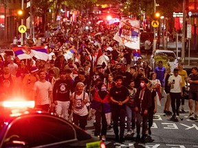 Serbian tennis fans march in Melbourne, Australia on January 10, 2022 in support of Novak Djokovic, who is fighting to play in the Australian Open which begins on January 17.