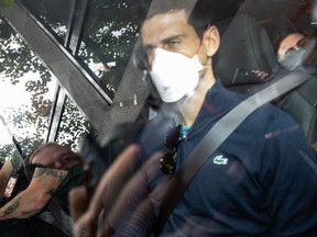 Serbian tennis player Novak Djokovic leaves the Park hotel on January 16, 2022 in Melbourne, Australia. Djokovic is in detention and faces deportation after his visa was cancelled by the Australian government. His appeal will be heard today, one day before he is scheduled to play in the Australian Open.