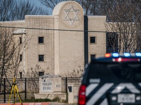 COLLEYVILLE, TEXAS - JANUARY 16: A law enforcement vehicle sits in front of the Congregation Beth Israel synagogue on January 16, 2022 in Colleyville, Texas.