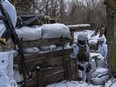 PISKY, UKRAINE - JANUARY 18: Viktor and Mykola (R), Ukrainian soldiers with the 56th Brigade, in a trench on the front line on January 18, 2022 in Pisky, Ukraine