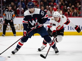 Trevor van Riemsdyk (57) of the Washington Capitals handles the puck as Alex Formenton (10) of the Ottawa Senators defends during the first period of the game at Capital One Arena on January 22, 2022 in Washington, DC.