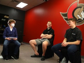 From Left, Zander Zatylny, 12 years old, interviews Senators’ Brady Tkachuk (centre) and Tim Stuetzle for his podcast yesterday.