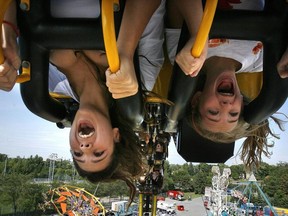 A 2007 file photo shows Alexandra Rodrigues and her sister Taylor enjoying the Fire Ball ride at Super Ex.