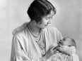 Elizabeth, then the Duchess of York, holds her daughter Elizabeth, the future Queen Elizabeth II of England.