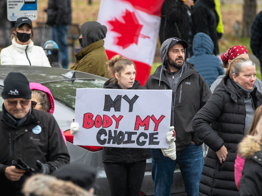 People gather to protest COVID-19 vaccine mandates and masking measures during a rally in Kingston, Ont., on November 14, 2021.