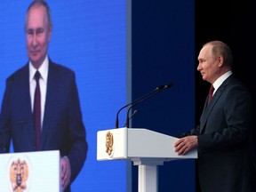 Russian President Vladimir Putin delivers a speech during an event at the State Kremlin Palace in Moscow.